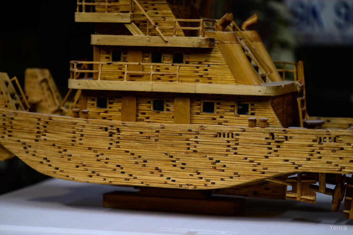 Close-up of a detailed boat model made from matchsticks showing layered construction and window details