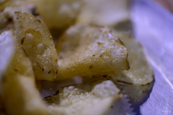 Macro view of salted potato chips on a surface