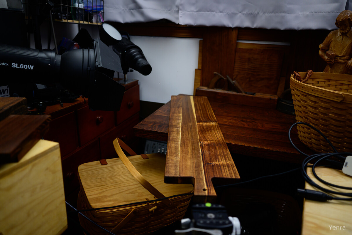 Photography lighting equipment set up in a macro studio next to a basket and wooden board.