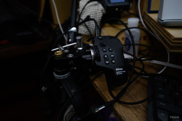 Nikon remote grip MC-N10 mounted on a rig with cables and desk equipment visible