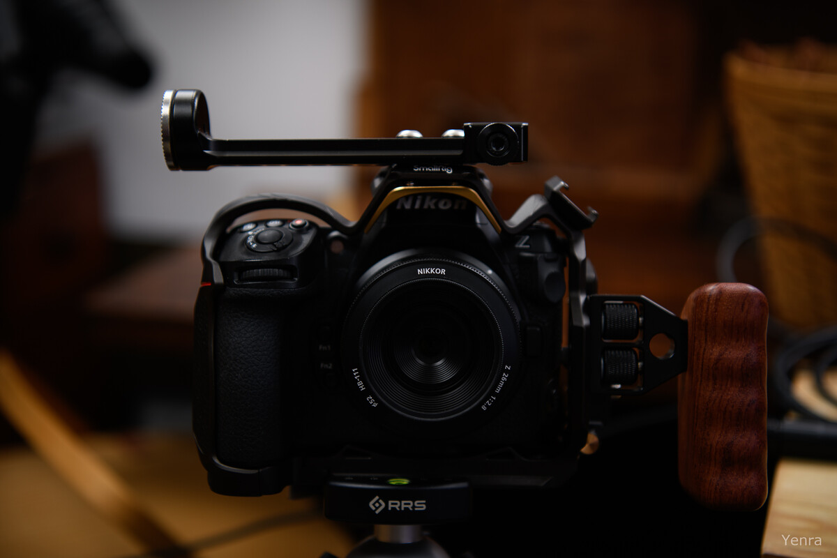 Rear view of a Nikon Z8 camera in an RRS cage with a wooden handle attached to the side.