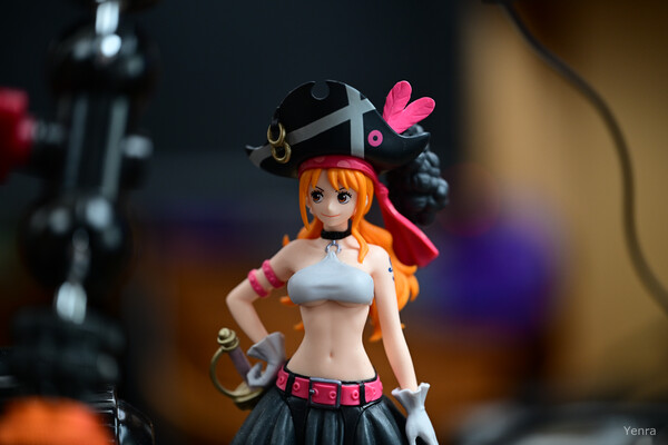 Close-up of Nami action figure in pirate attire with blurred background