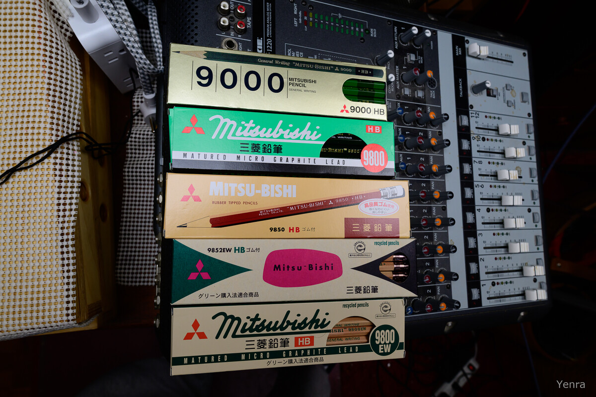 Stack of Mitsubishi pencil boxes on an audio mixer