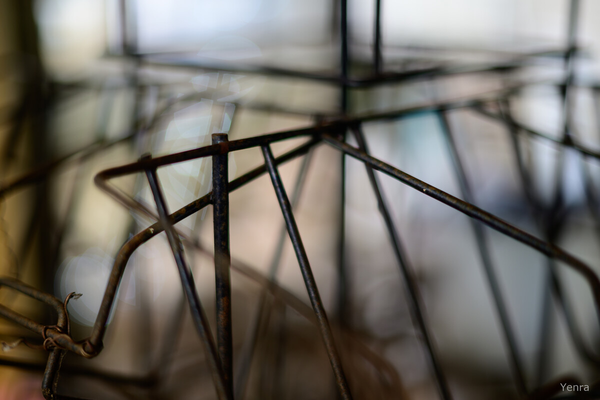 Close-up of a rusty wire book rack with a blurred background