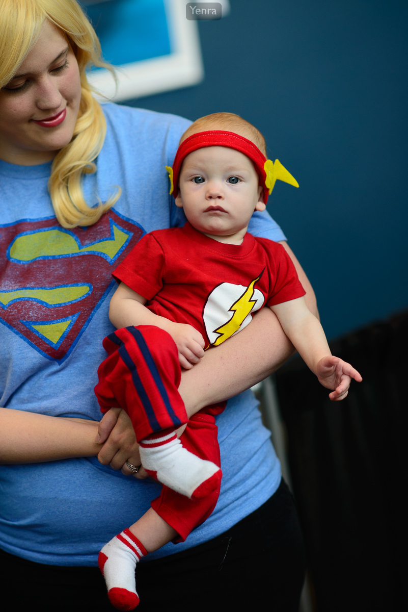 Baby Flash is held by Super Mom