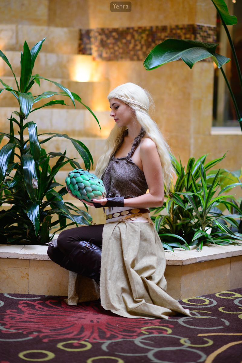 Daenerys caring for a dragon's egg