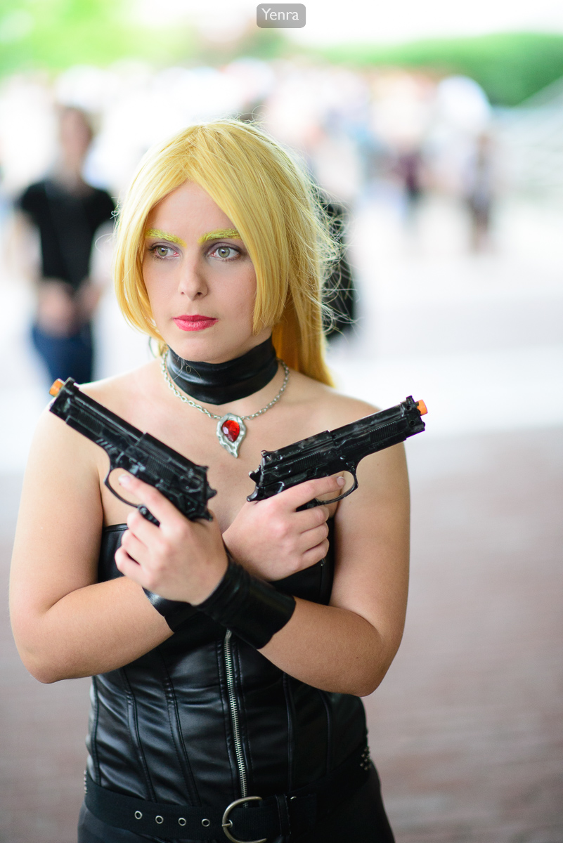 A woman dressed in a black leather corset and pants holds two guns in front of her chest.