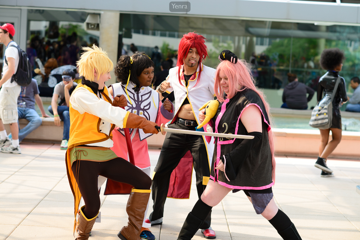 Four individuals dressed as characters from 'Tales of the Abyss' pose for a photo at an event or convention.