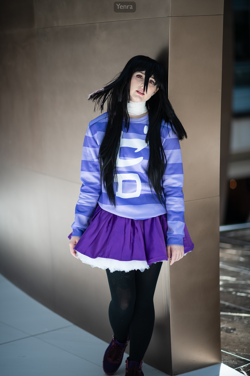 A young woman posing for the camera in a purple and white striped shirt with the number '56' on it.