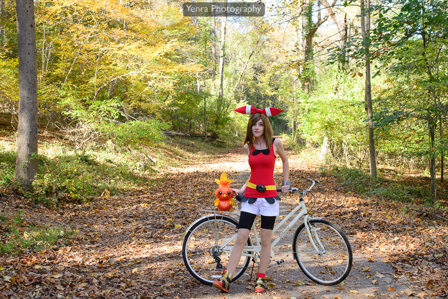 Pokemon trainer May by her bike with Torchic